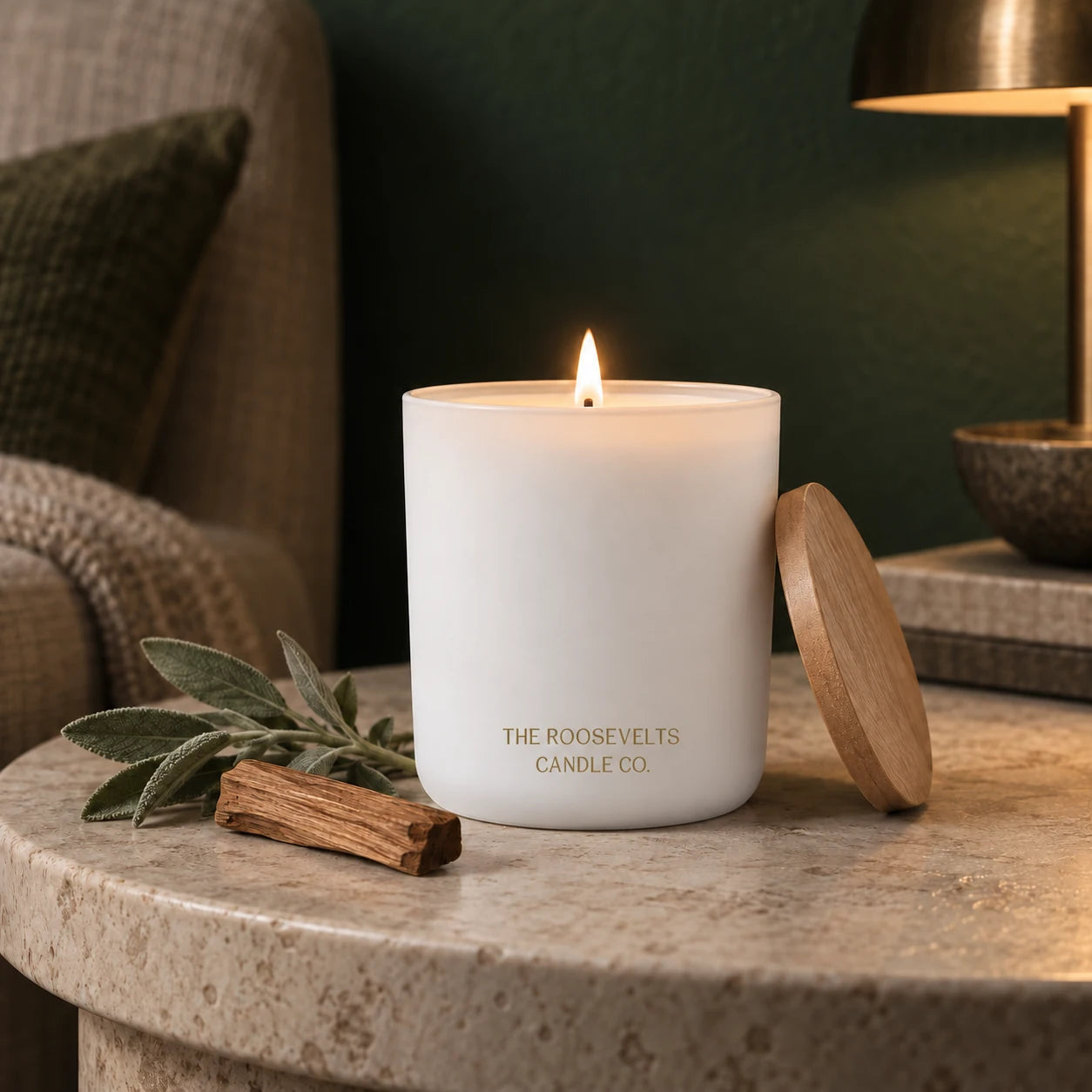 Grand Teton Candle candle lit in a quiet forest-green interior
