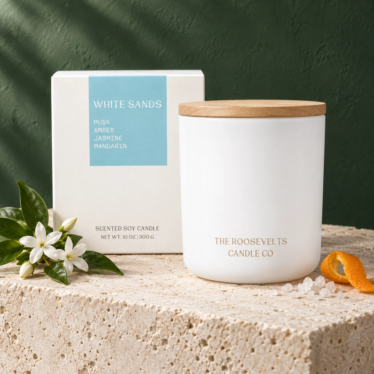 White Sands Candle candle and box in a forest-green and limestone still life