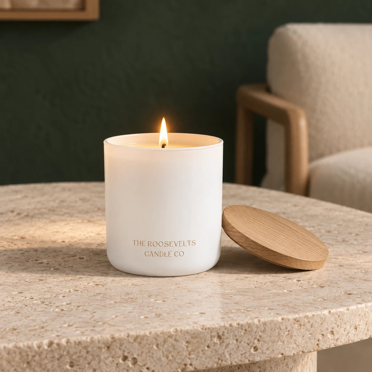 White Sands Candle candle lit in a quiet forest-green interior