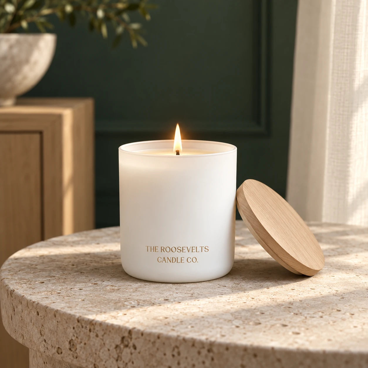 Zion Candle candle lit in a quiet forest-green interior